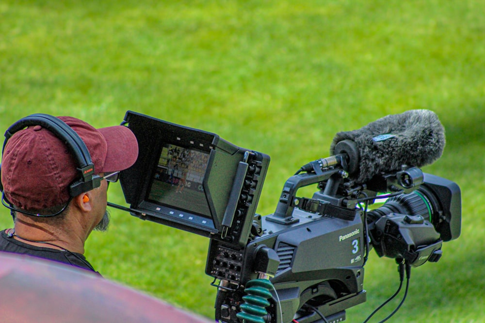 a man with headphones and a microphone on a tripod