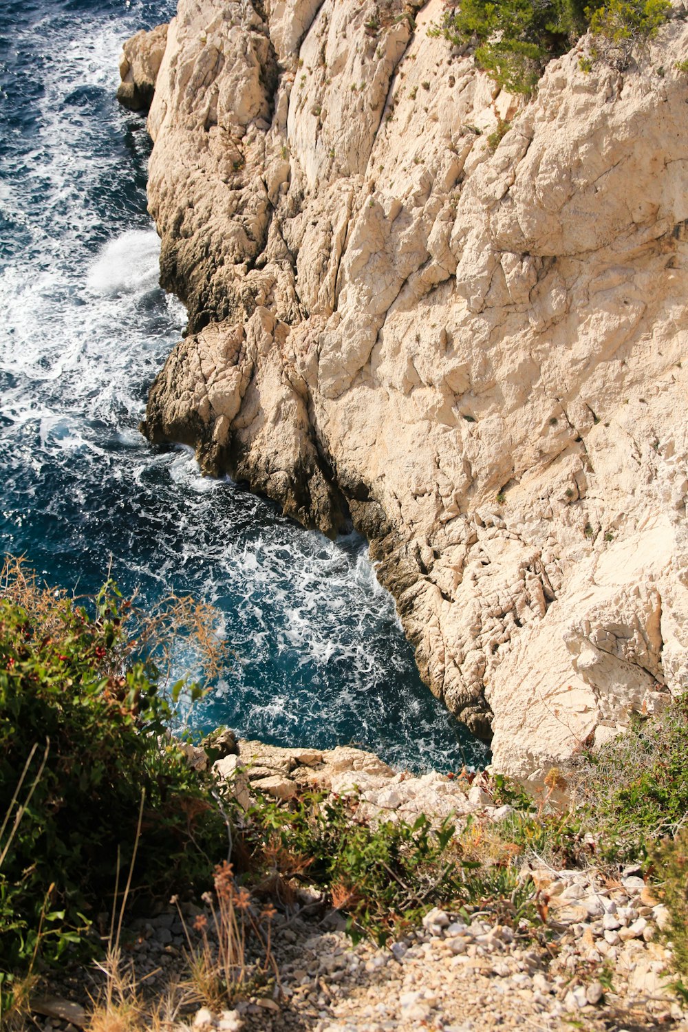 a rocky cliff overlooks a body of water