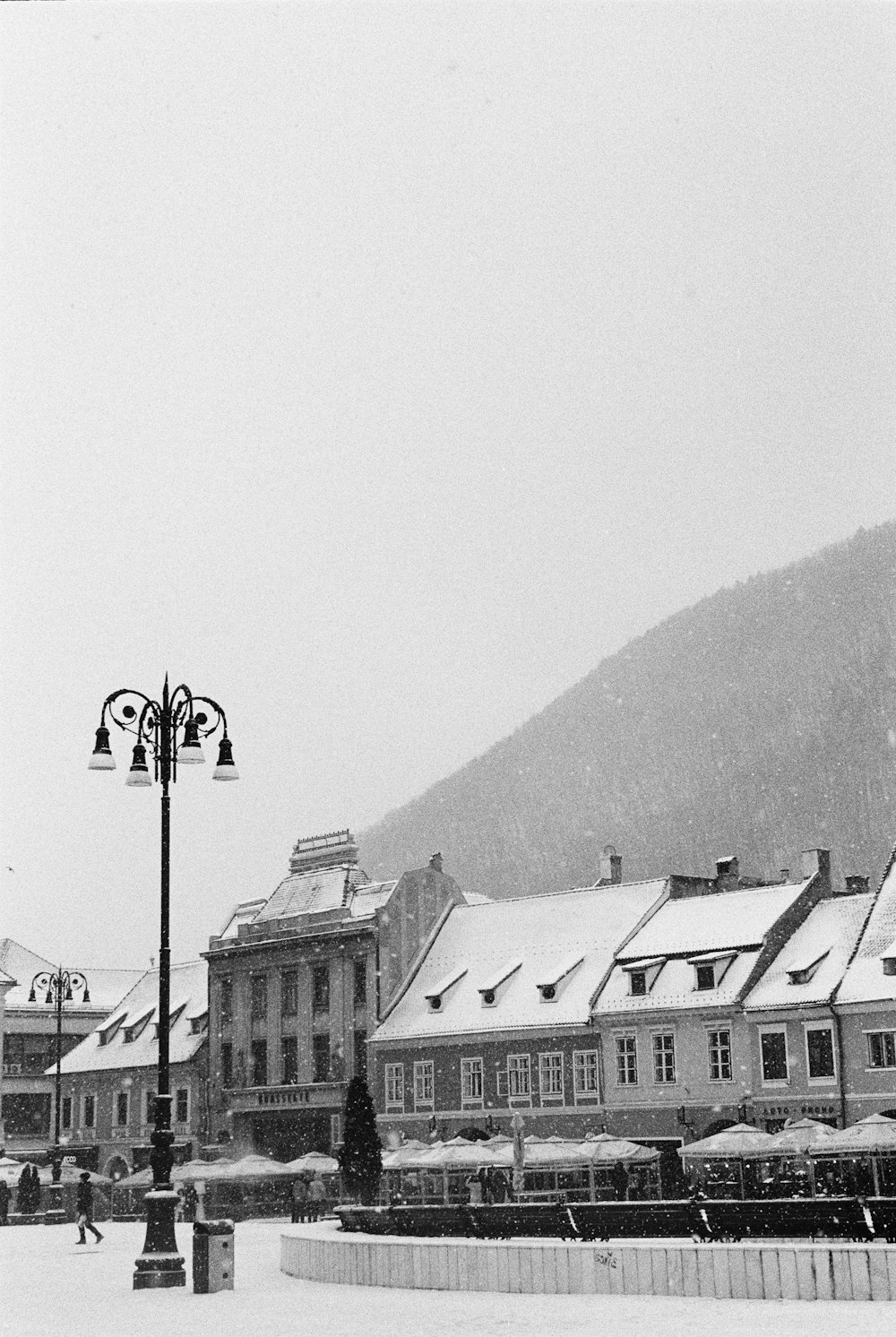 a black and white photo of a town in the snow