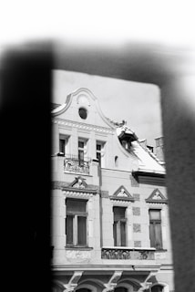 Exterior of a home painted in classic black and white with gold trim highlighting architectural details.