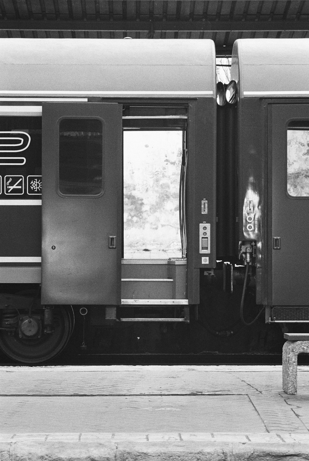 a black and white photo of a train at a station