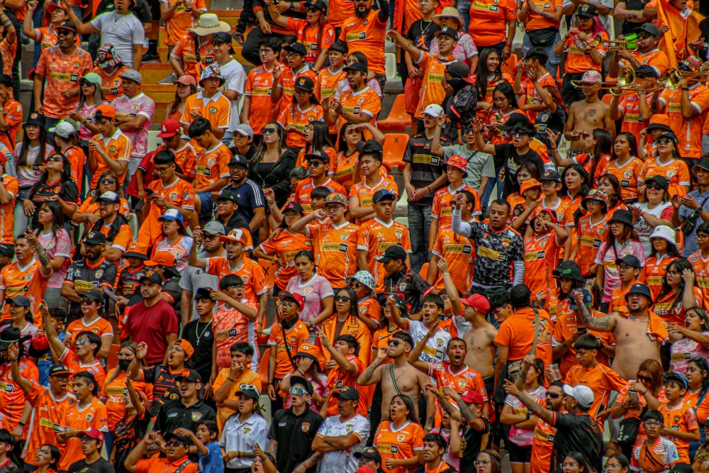 a large group of people in orange shirts