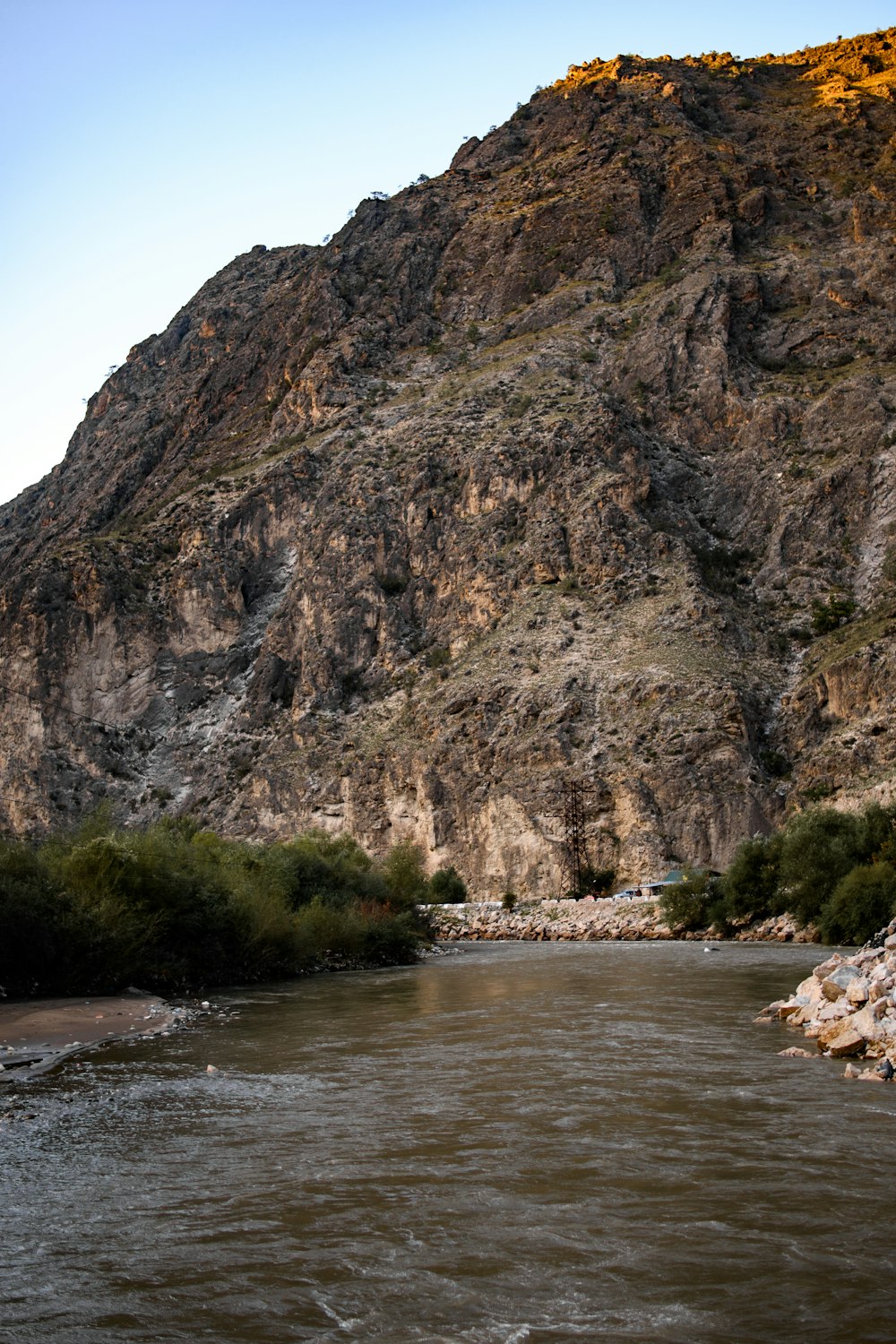 a mountain side with a river running through it