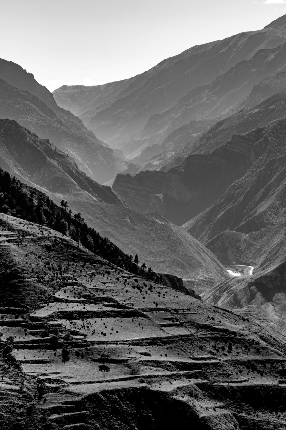 a black and white photo of mountains and valleys