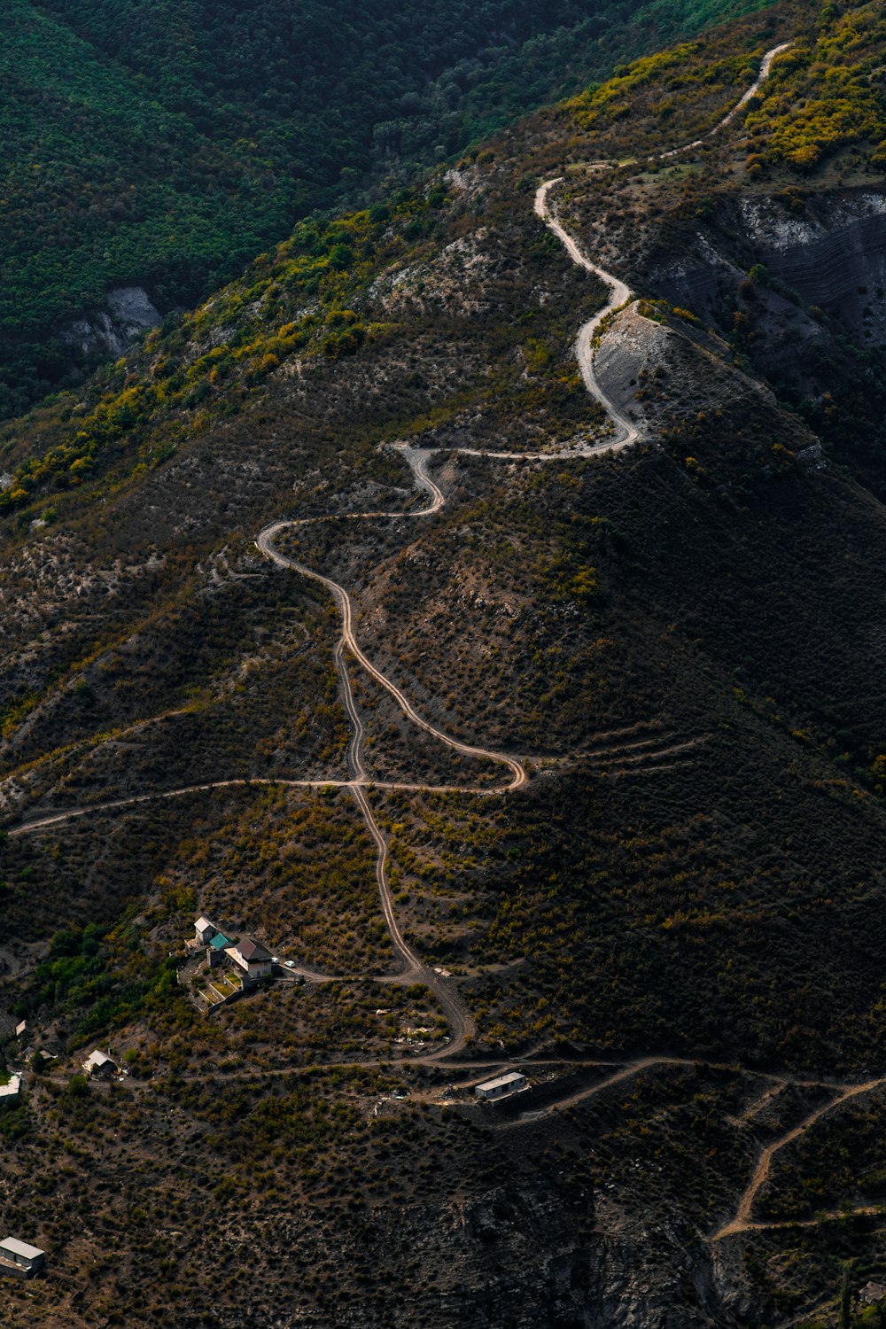 an aerial view of a winding road in the mountains