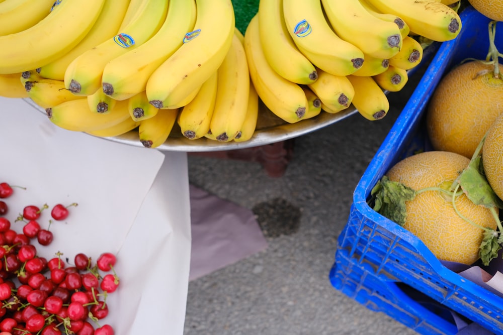 a bunch of bananas and other fruit on a table