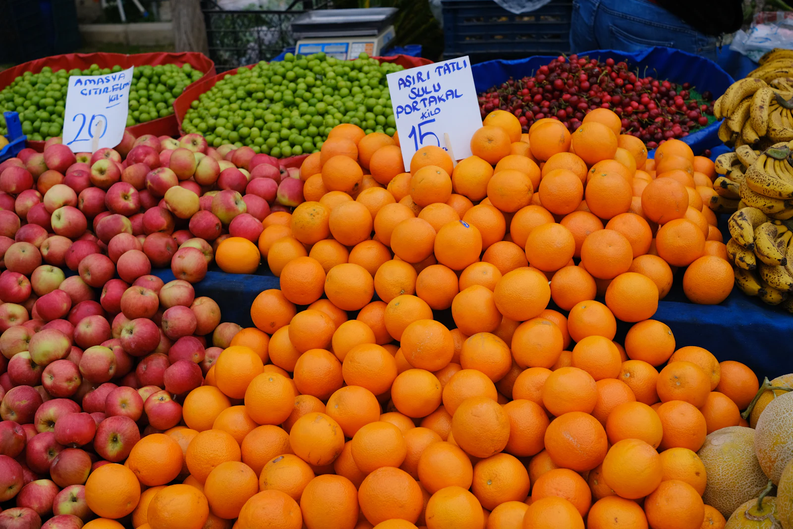Piles of oranges and apples on a market stall in Turkey