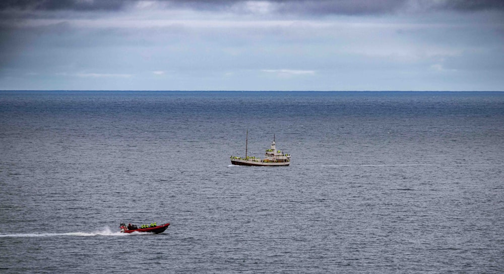 a small boat in the middle of a large body of water