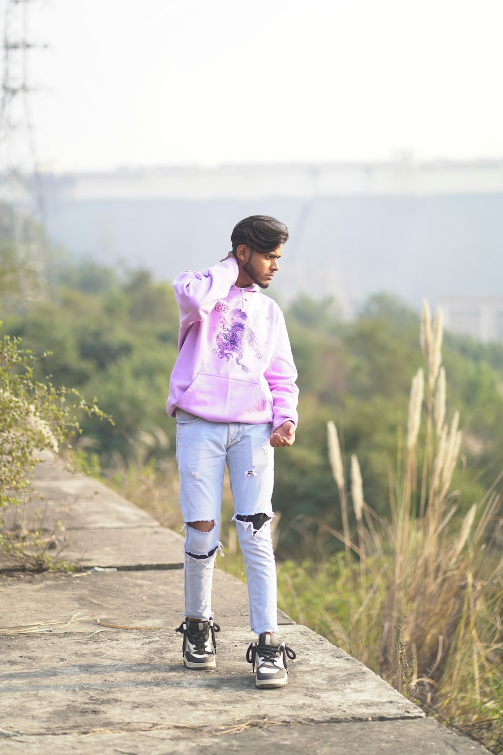 a person standing on a ledge with a skateboard