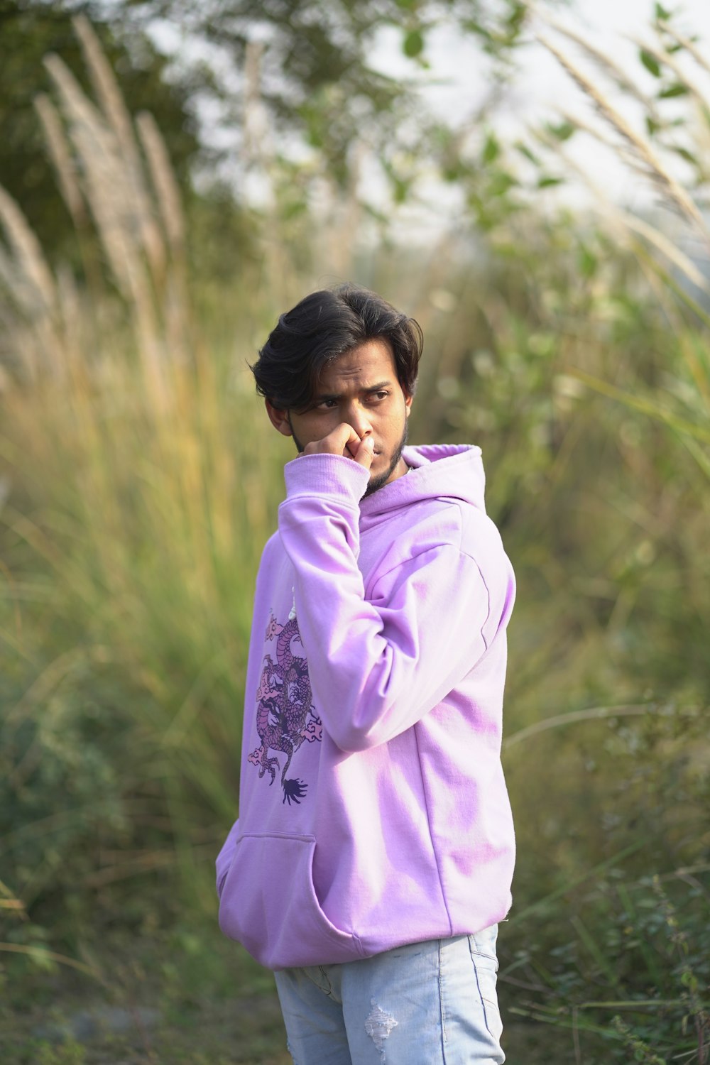 a woman in a purple jacket is talking on a cell phone