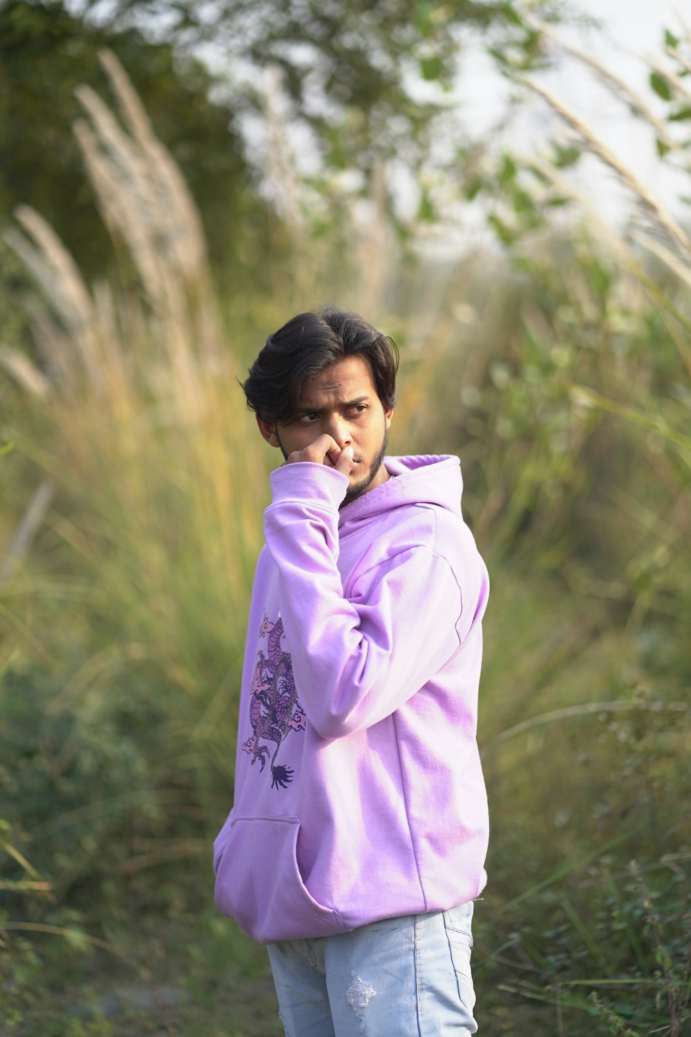 a woman in a purple jacket talking on a cell phone