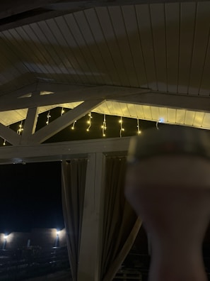 Ambient lighting casting warm hues over an evening event inside the shelter.