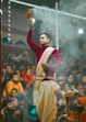a man in a red and white outfit holding a candle