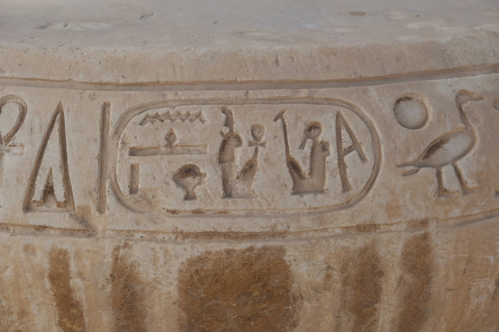 a close up of a stone object with writing on it