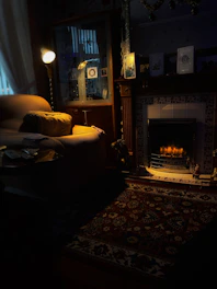 Interior shot showing the warm fireplace and plush furnishings in the living area.