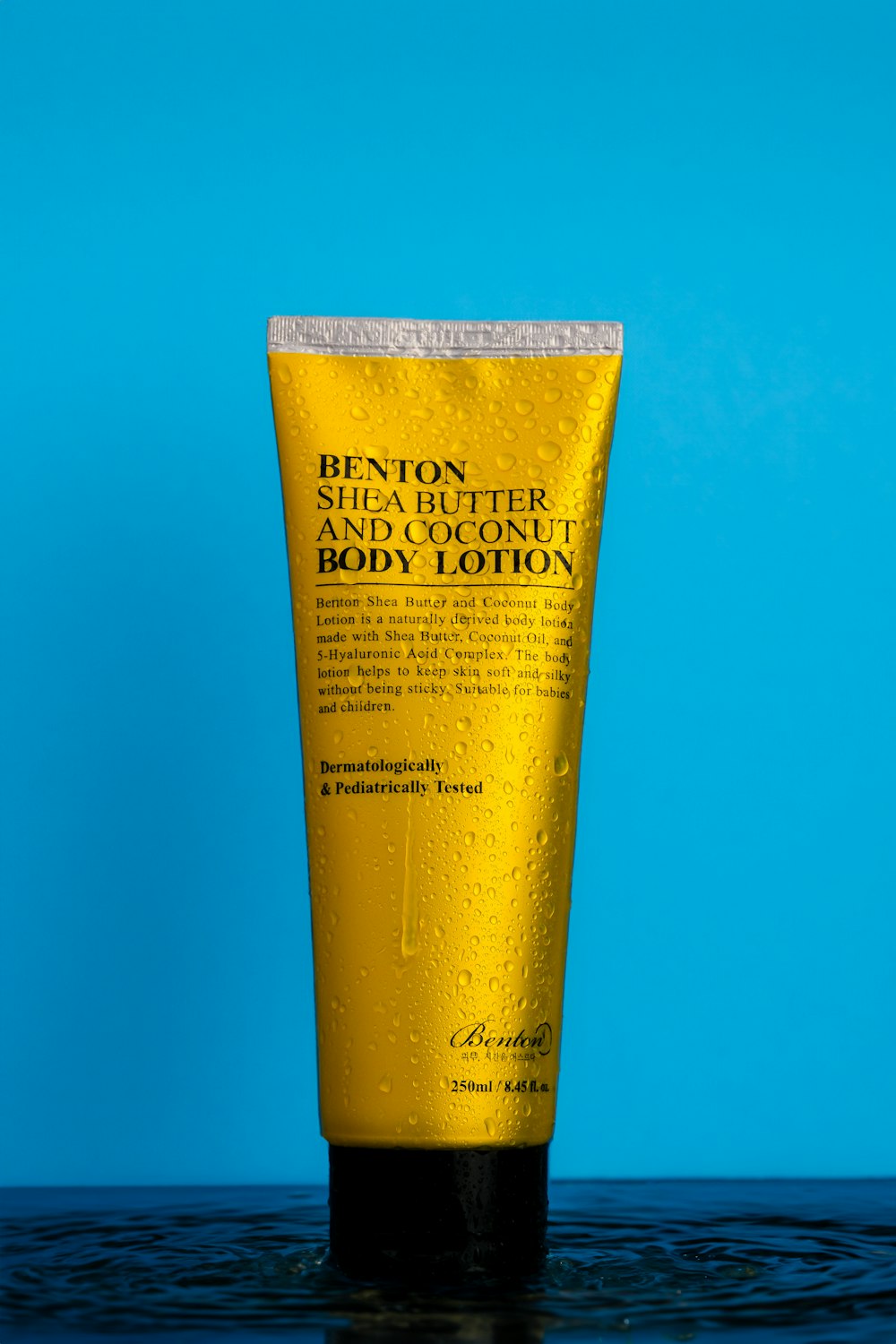 a tube of body lotion sitting on top of a table