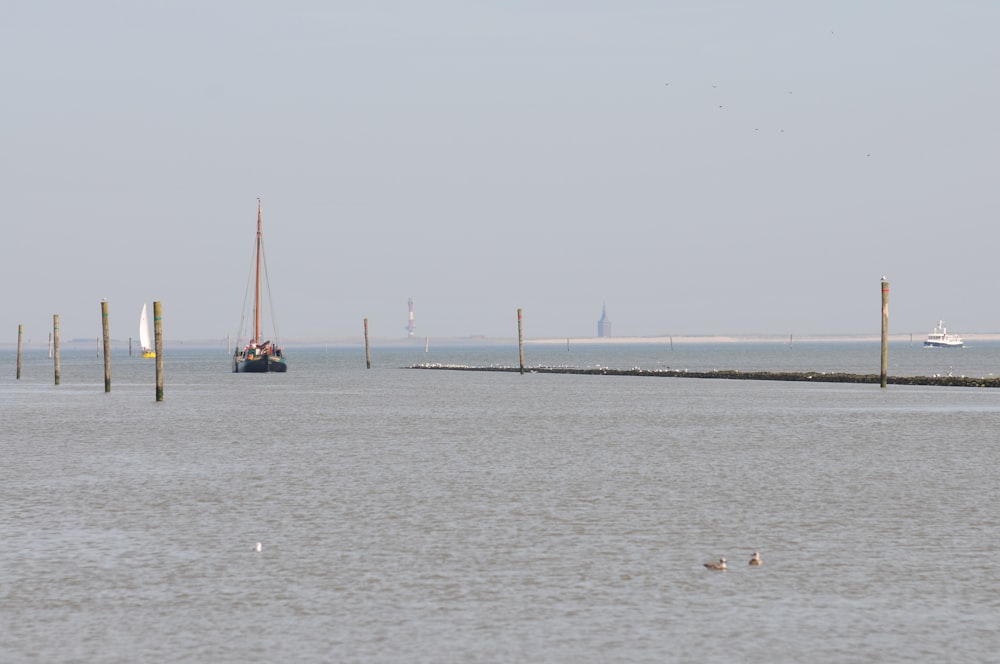 a large body of water with a boat in the distance