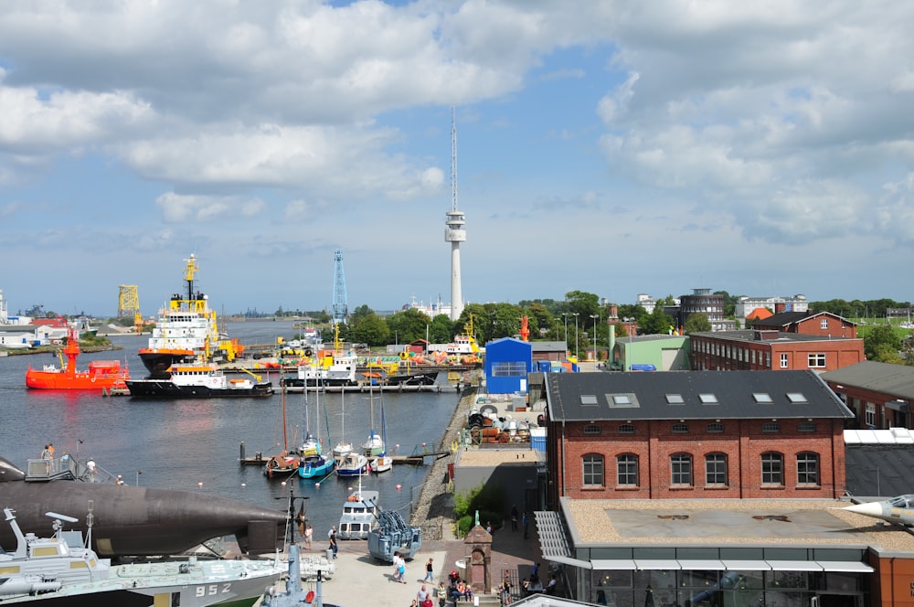 a harbor filled with lots of boats next to tall buildings