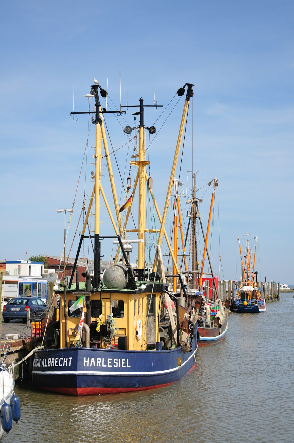 a blue and yellow boat sitting in the water