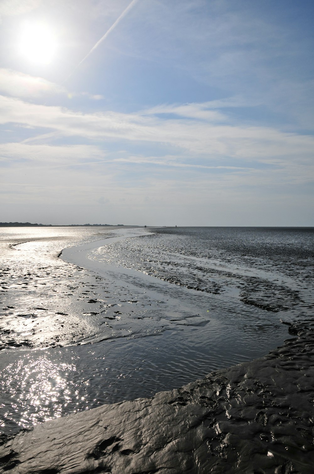 the sun shines brightly over the water at the beach