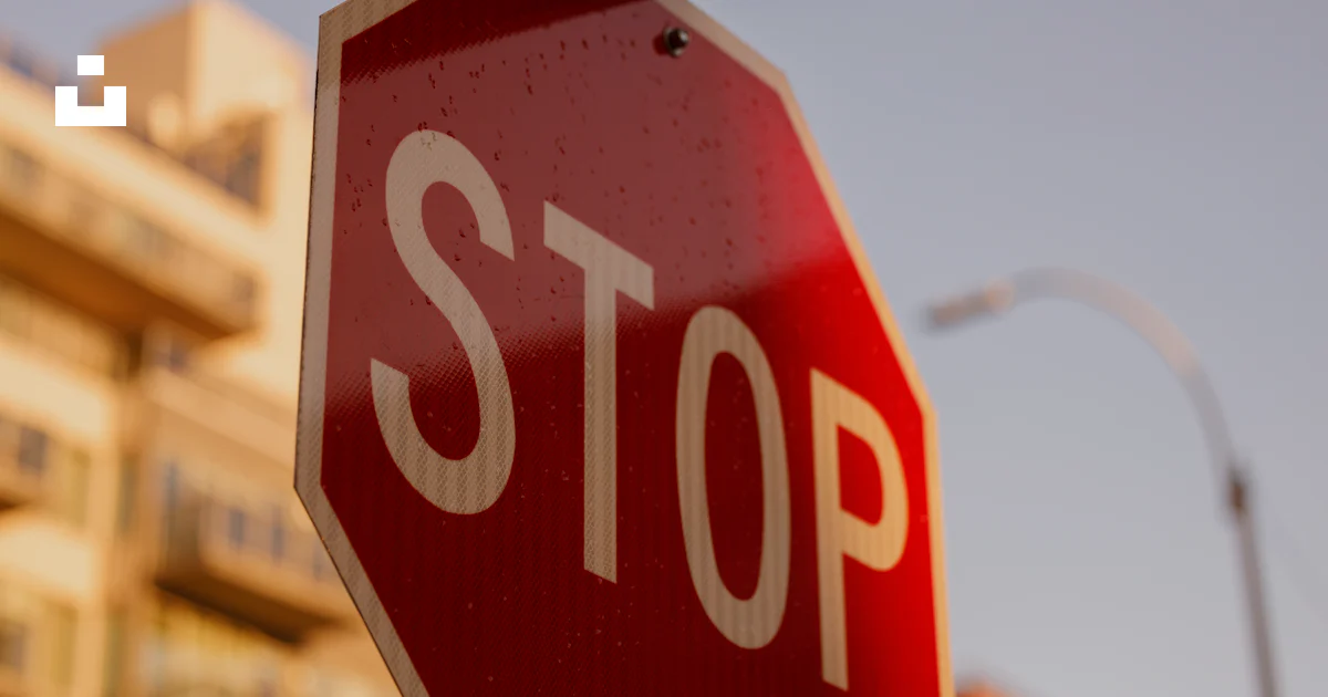 Stop Builing Sign A close up of a stop sign with a building in the background photo ...