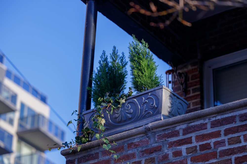 a brick wall with a planter on top of it