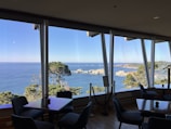 Spacious ocean view room with large windows and natural light.