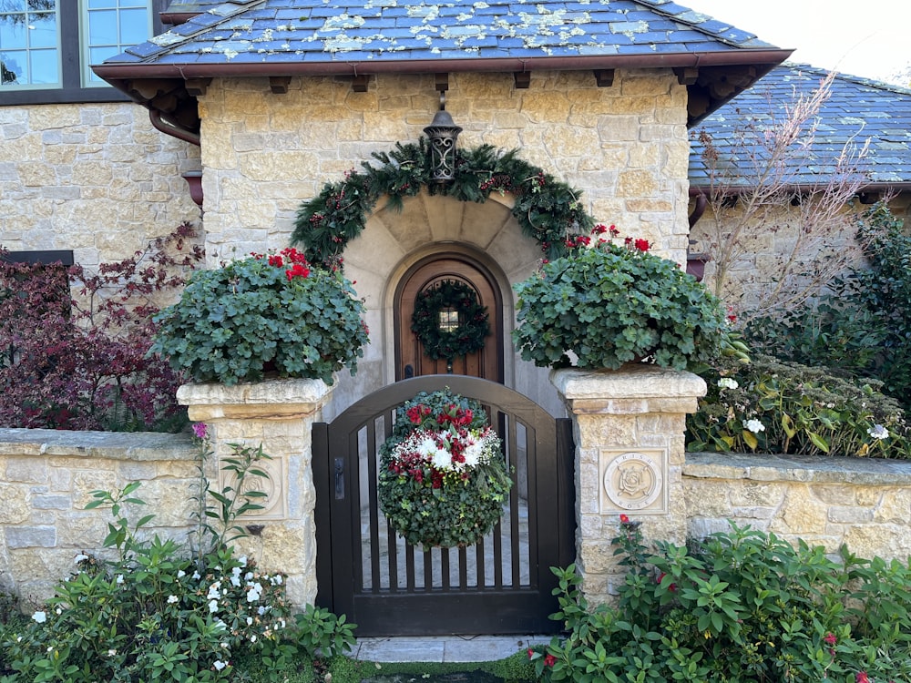a stone house with a wreath on the front door