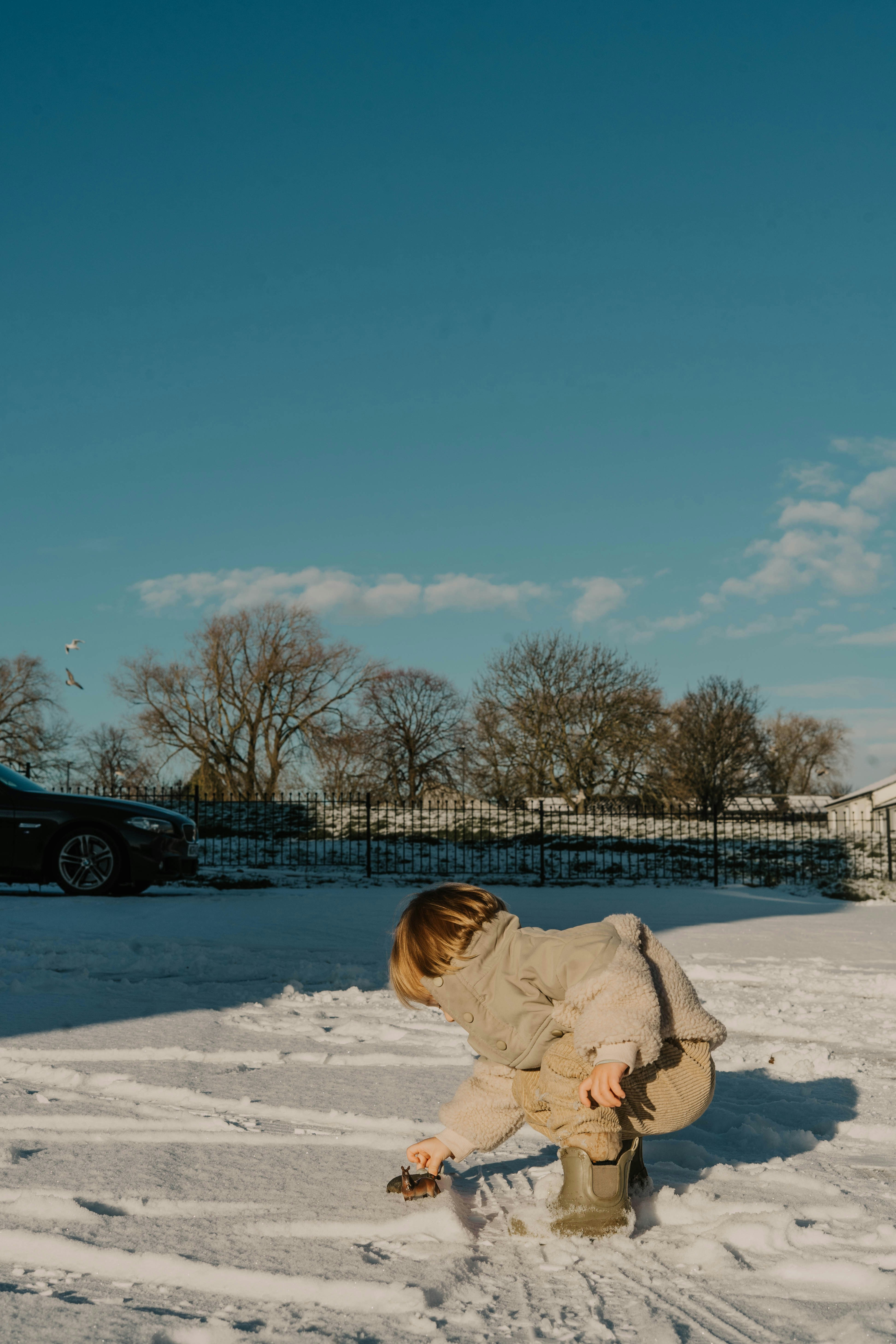 a person kneeling down in the snow with a snowboard