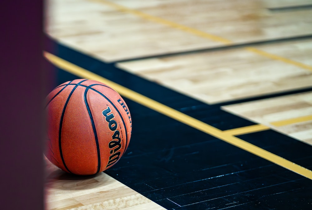 a basketball sitting on top of a basketball court