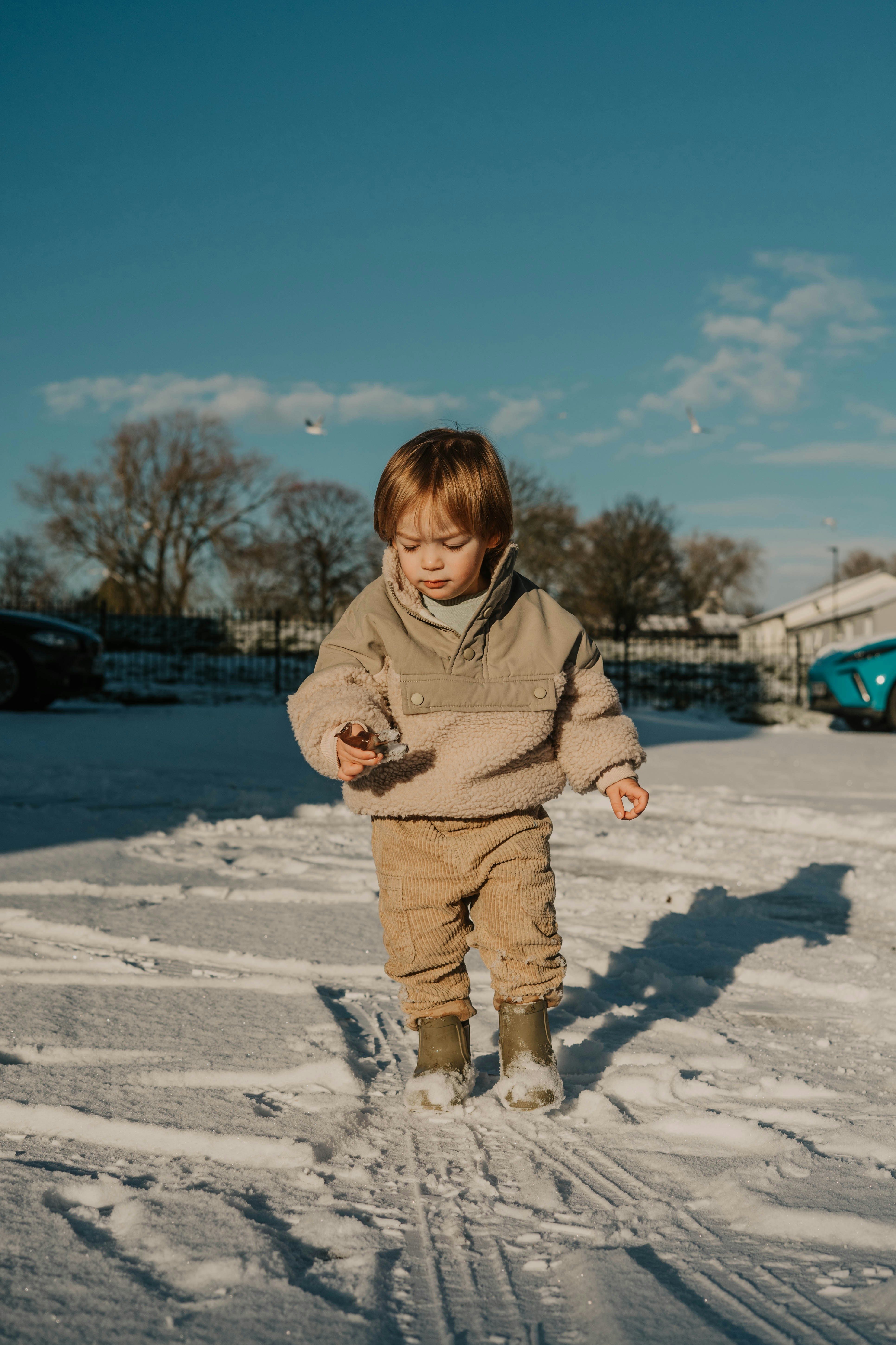 a little boy that is standing in the snow