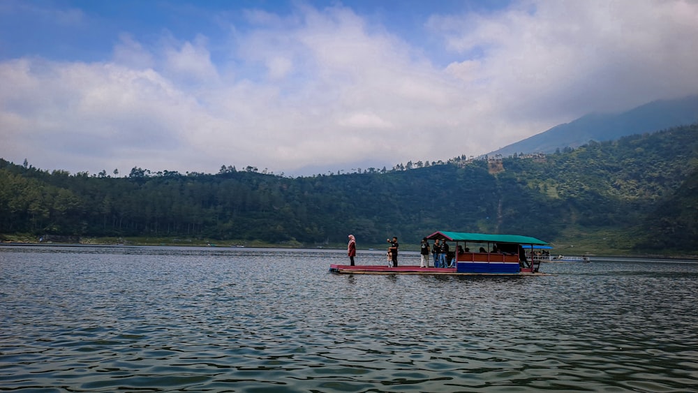 a group of people standing on a boat in a lake