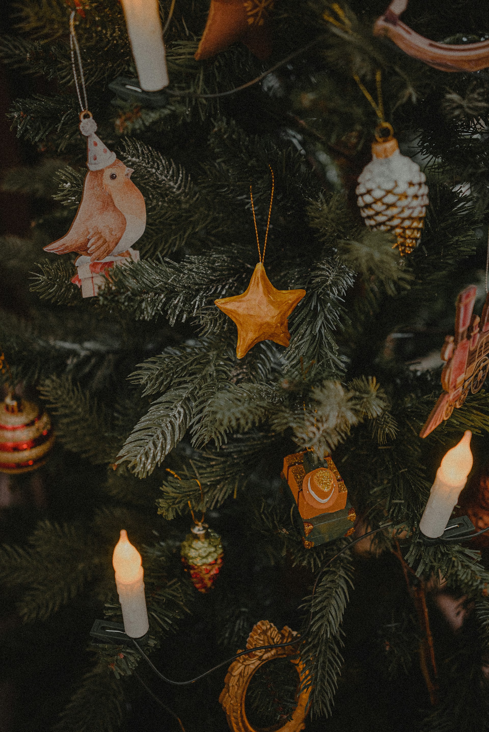 a close up of a christmas tree with ornaments on it