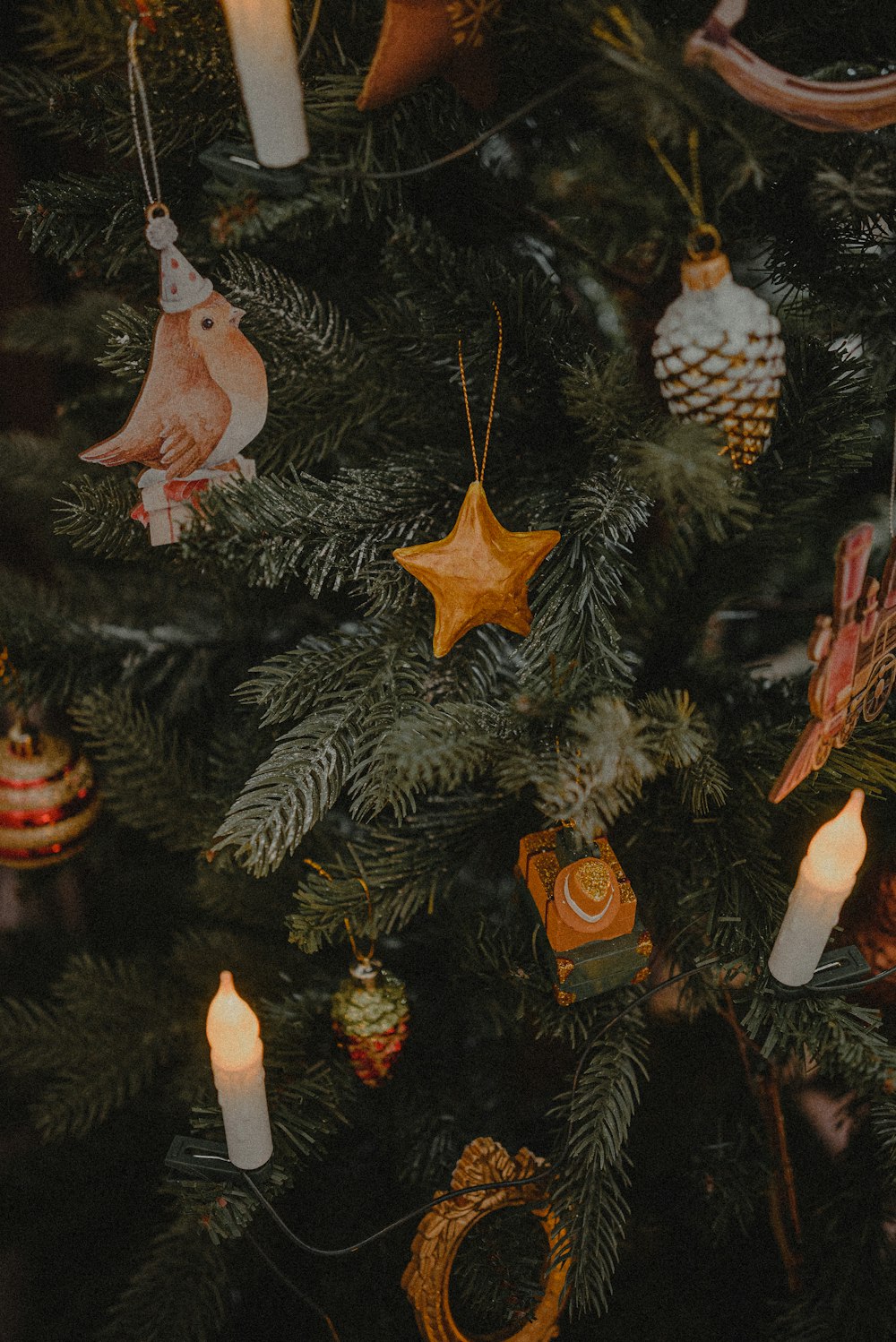 a close up of a christmas tree with ornaments on it