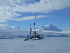 A remote desert monitoring station with automated equipment under a clear sky