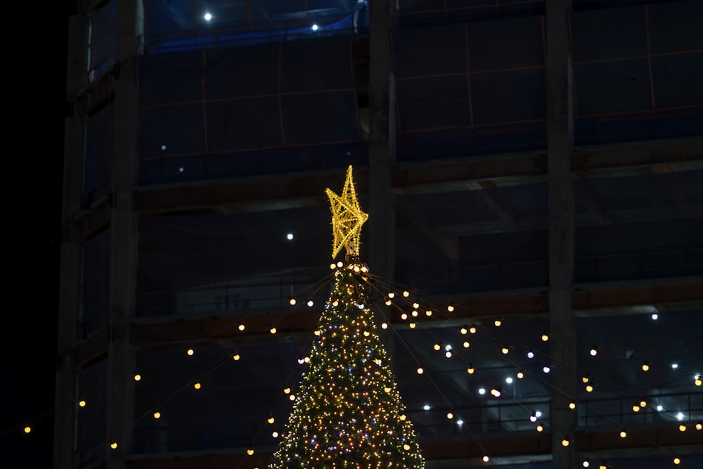 a lighted christmas tree in a large building