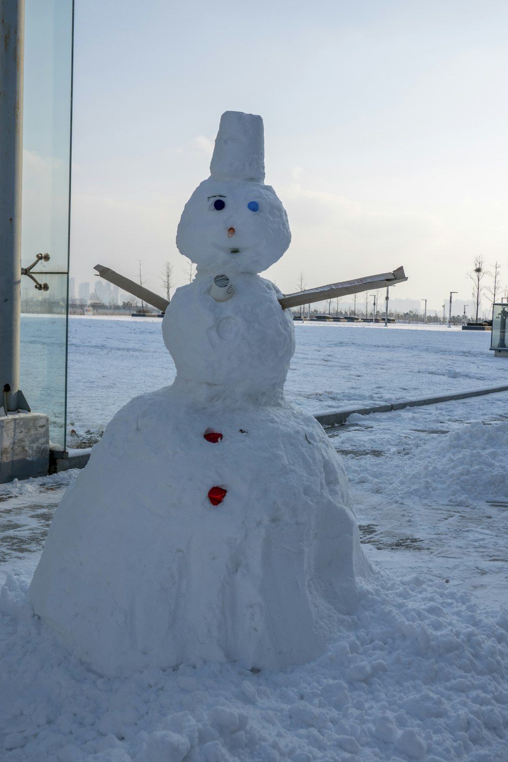 a snowman made out of snow in front of a building