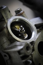 Close-up of a mechanic working on a large engine component with precision tools.