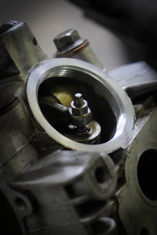 Close-up of a technician inspecting a diesel engine component with care.
