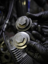 Close-up of hands exchanging automotive parts in a warehouse.