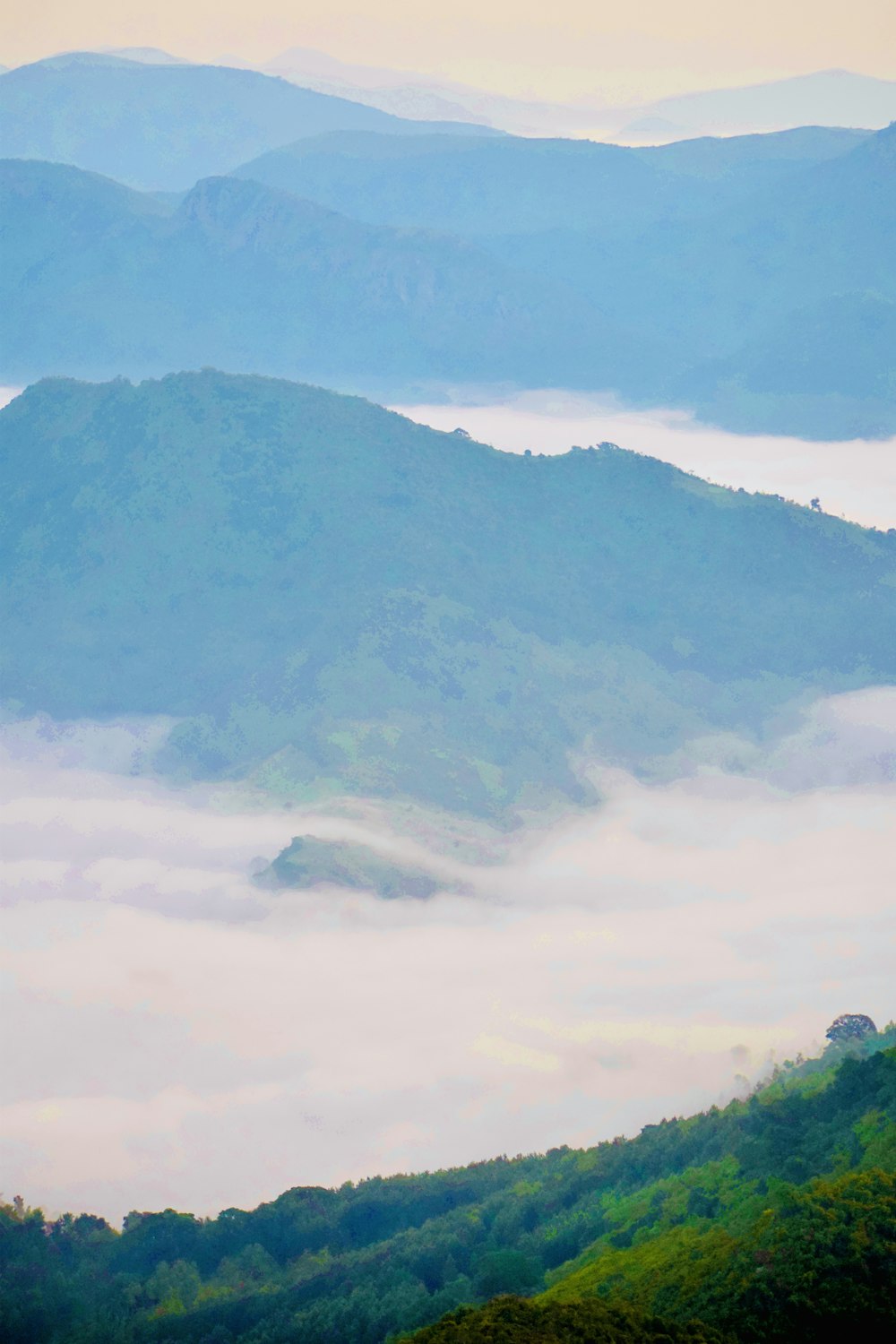 a view of a mountain range covered in fog