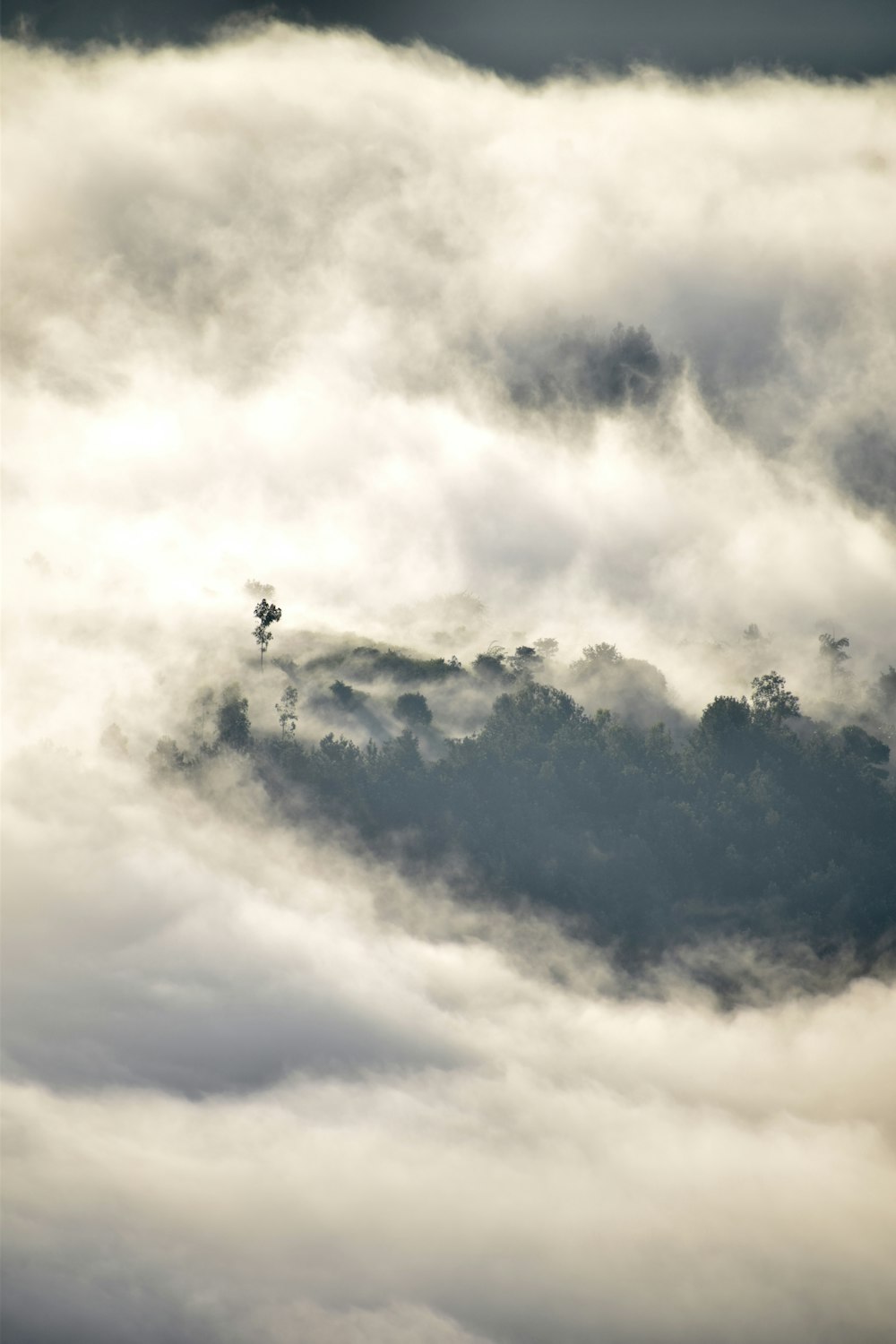 a plane flying through the clouds in the sky