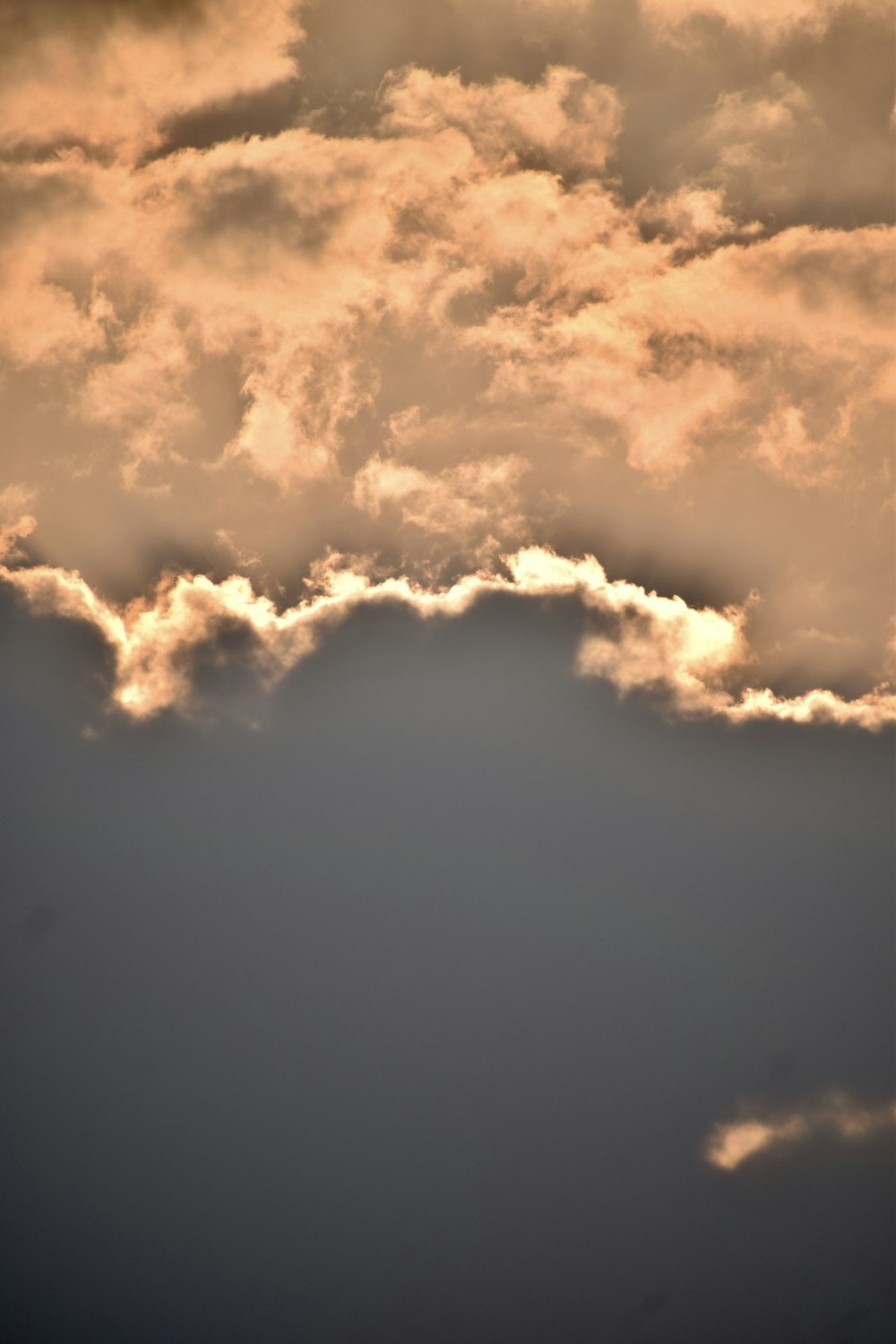 a plane flying in the sky with a lot of clouds