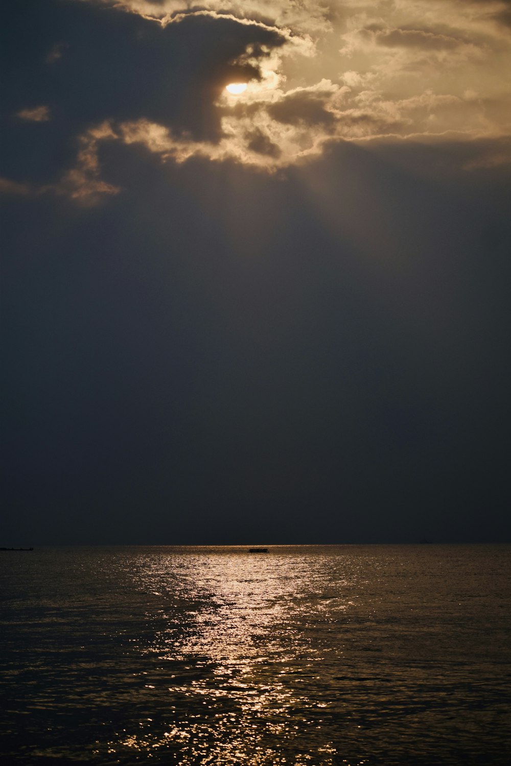 a large body of water under a cloudy sky