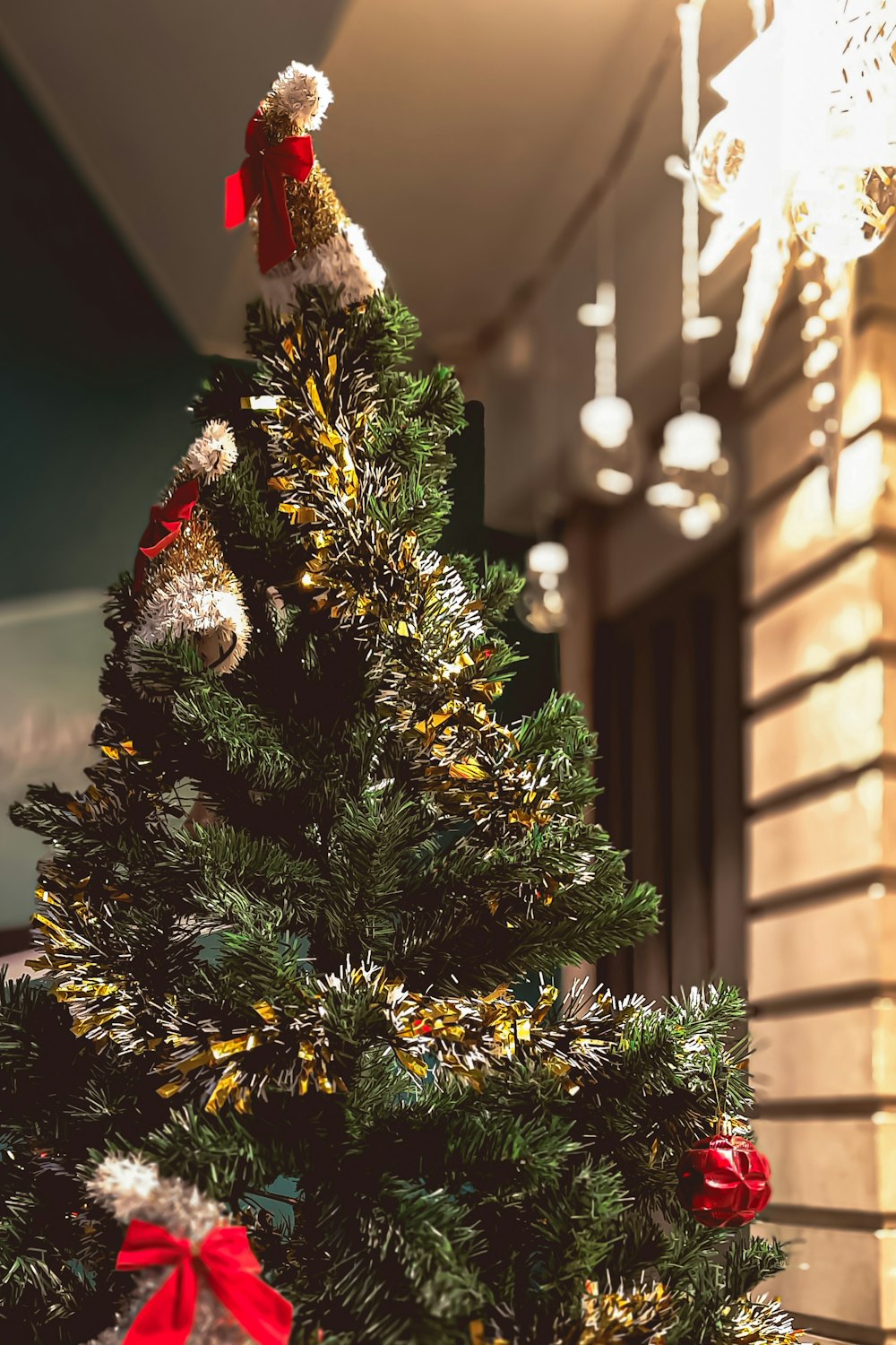 a christmas tree with a teddy bear on top of it