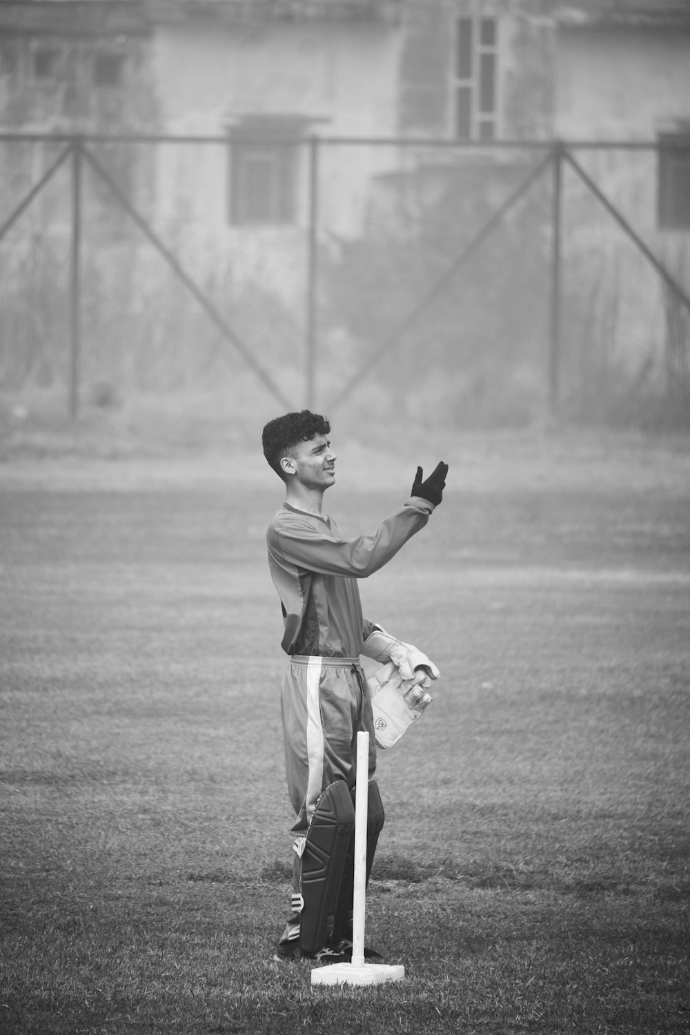 a young man standing on top of a baseball field