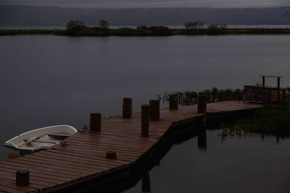 a boat is docked on a wooden dock