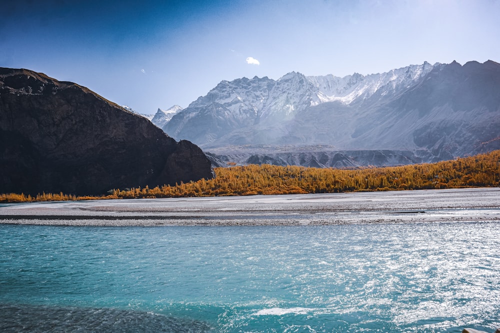 a body of water with mountains in the background