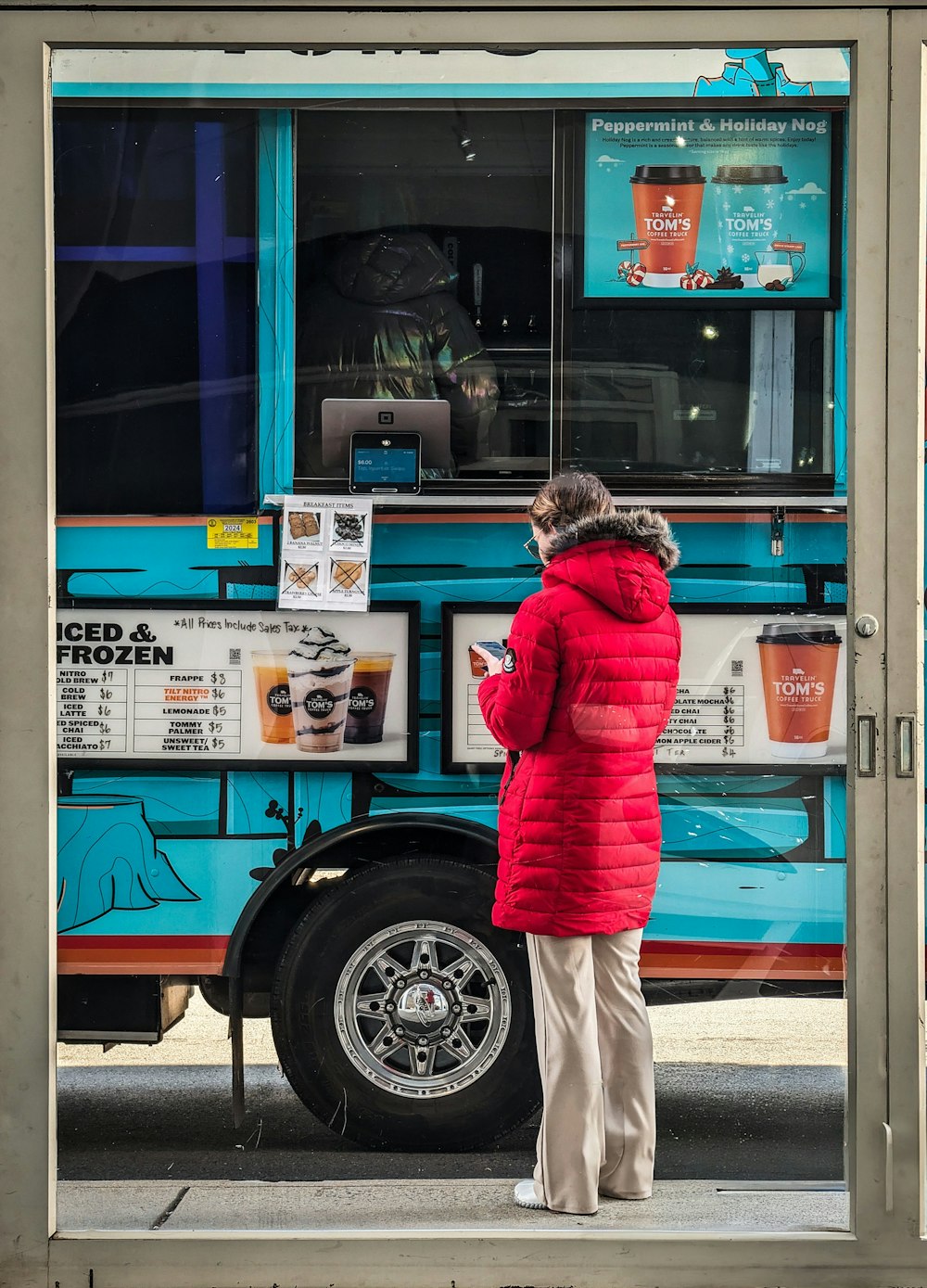 a woman standing in front of a food truck