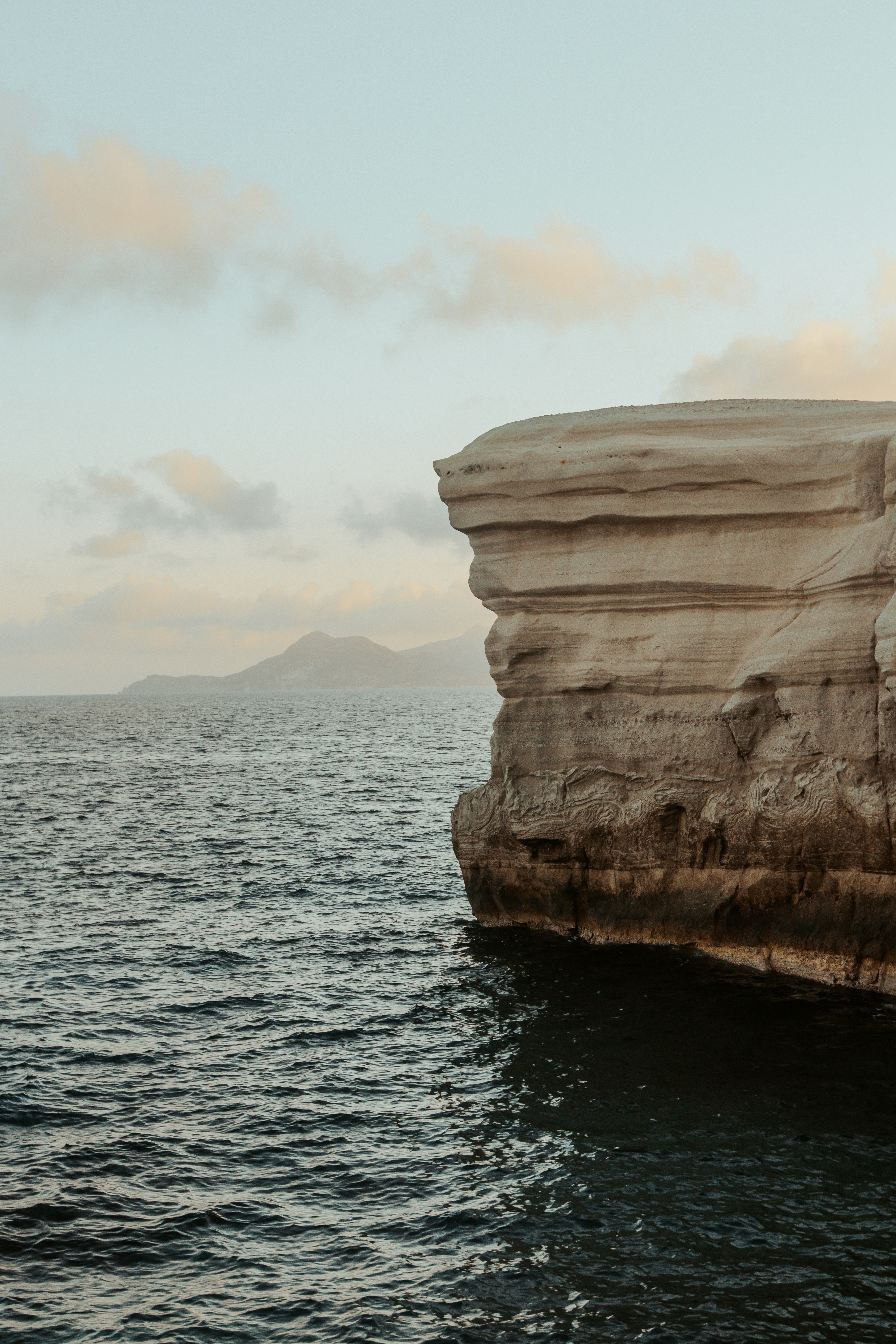 a large rock outcropping in the middle of a body of water
